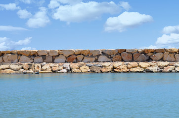Stone walkway in the sea stormy clouds in the sky