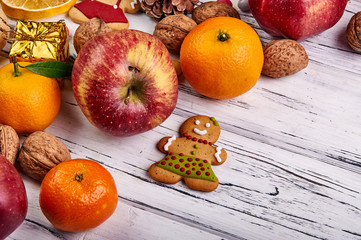 Gingerbread, fruit and nuts for New Year's holidays. Fresh farm products. The gingerbread girl in a...