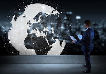 Businessman watching digital planet earth interface on a rooftop 3D rendering