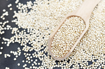 Quinoa in wooden spoon, gluten free ancient grain for healthy diet