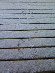 Foot prints in snow covered decking