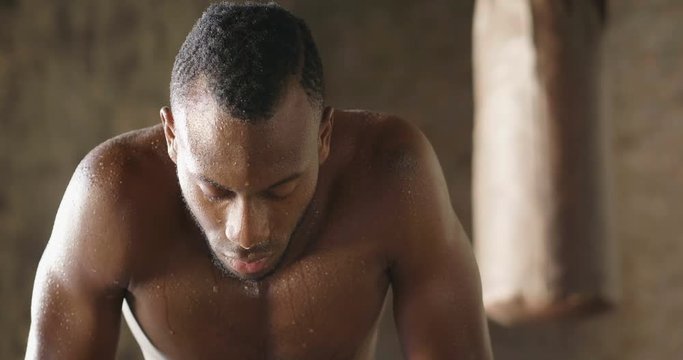  00:14 | 00:17 1&times;  A muscular and sweaty man is training at the gym by lifting the gym weights to strengthen his muscles. Concept of: workout, workout, power, supplements, fitness