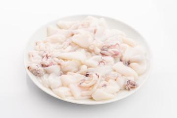raw calamari on plate isolated on white