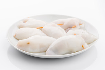 raw calamari on plate isolated on white