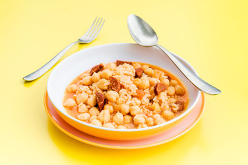 stewed chickpeas in modern dish on yellow table