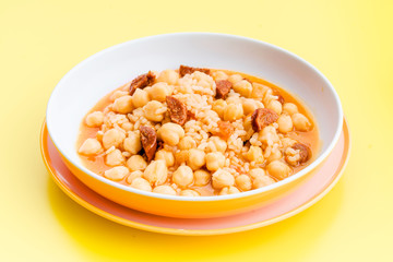 stewed chickpeas in modern dish on yellow table