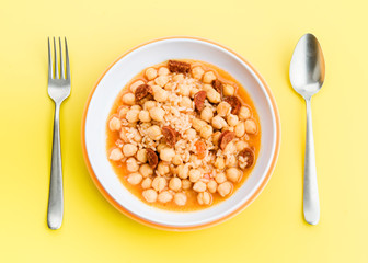 stewed chickpeas in modern dish on yellow table
