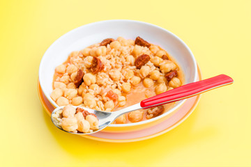 stewed chickpeas in modern dish on yellow table