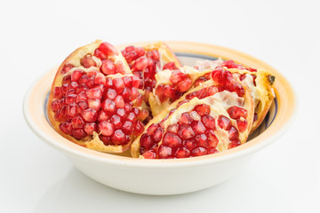 pomegranates on plate isolated on white