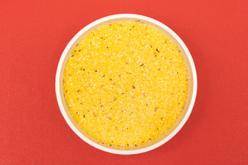 cornmeal a bowl on a colored background	
