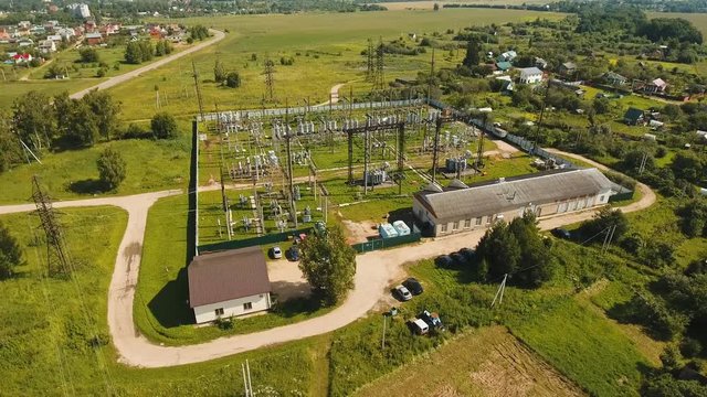 Aerial view Power plant, transformation station, cables and wires. High voltage electric power substation. Electrical power transformer in high voltage substation, 4K, aerial footage.