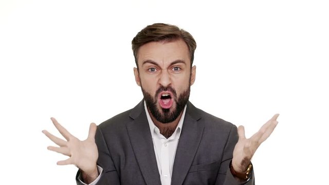 Portrait of outraged man having beard and mustaches shouting in anger being displeased demonstrating his indignation with hands over white background slomo. Concept of emotions