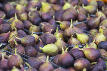 Background of ripe juicy figs on the market stalls shot close-up