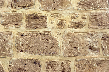 Stone old wall background with large-sized stones close-up