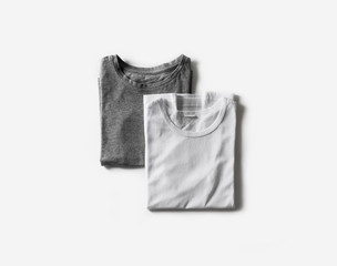 Blank folded white and gray t-shirts. Tshirt mockup for your own graphics. Flat lay.