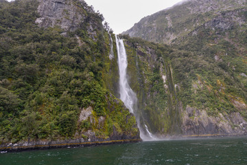 Fototapeta na wymiar Waterfall in Milford Sound New Zealand