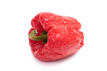 Obraz premium Old wrinkled red bell pepper on white background