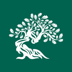 Fototapeta premium Huge and sacred oak tree silhouette logo badge isolated on green background.