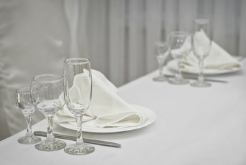 Glass dishes on a table on a white tablecloth