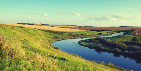 Naklejka premium Sunny summer landscape.River Upa in Tula region, Russia.Wheat fields an sunrise.Beautiful view. 