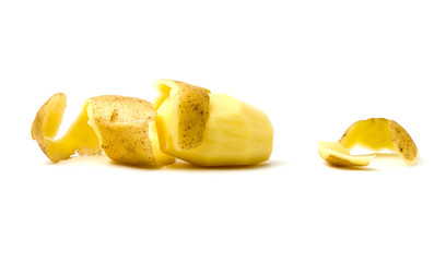 Peeled potatoes on a white background. Raw peeled potatoes and peelings close-up.