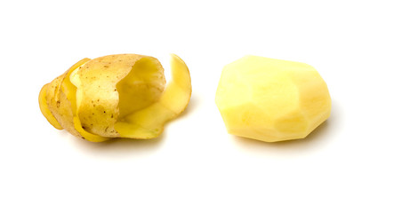 Peeled potatoes on a white background. Raw peeled potatoes and peelings close-up.