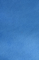 The blanket of furry blue fleece fabric. A background texture of light blue soft plush fleece...