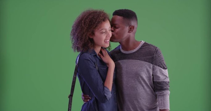 Young black couple admire something on green screen. On green screen to be keyed or composited. 