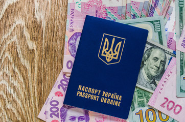 International Ukrainian passport with Hryvna banknotes on US dollars background.