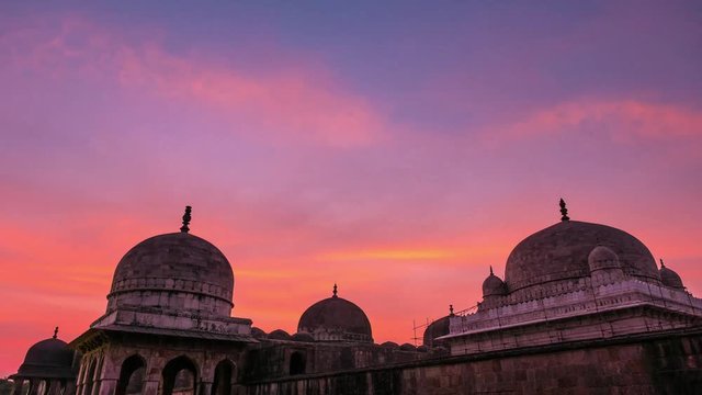 Time lapse Mandu India, afghan ruins of islam kingdom, mosque monument and muslim tomb. Colorful sky at sunrise.