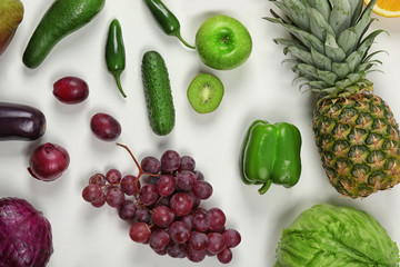 Creative composition made of fruits and vegetables in rainbow colors on white background, flat lay