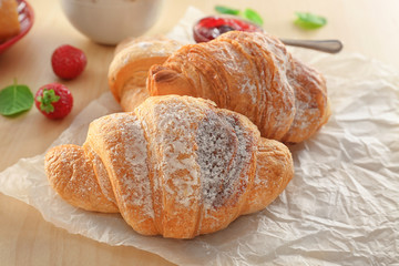 Tasty croissants on table, closeup