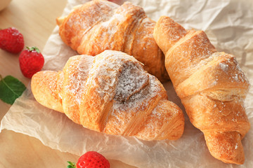 Tasty croissants on table, closeup