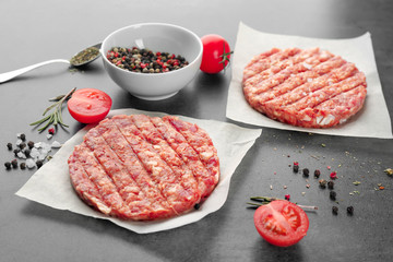 Raw burger patties on table