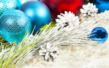 New year decorations on white beads background with balls and fir tree
