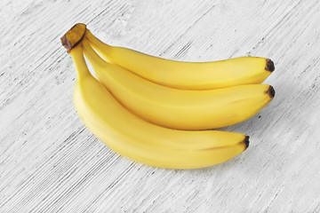 Tasty ripe bananas on wooden background