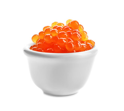 Delicious red caviar in ceramic bowl on white background