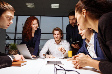 Business executive delivering presentation to his colleagues during meeting or in-house business...