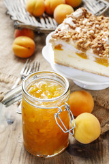 Jar of peach jam and cheese cake