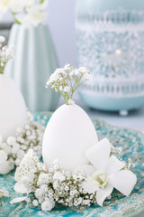 Decoration with goose egg, orchid flowers and gypsophila paniculata twigs.