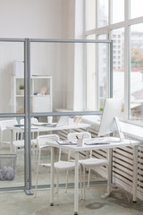 Place of work by window with two chairs, desk and office supplies