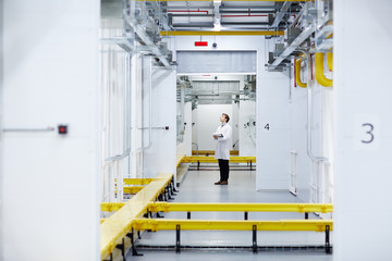 Technical engineer carrying out investigation or making revision of mining farm systems