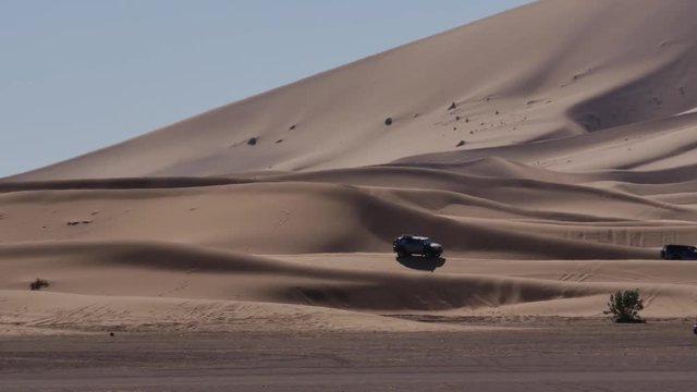 Four wheel drives in the Sahara, traditional entertainment for tourists in Moroccan desert  4K