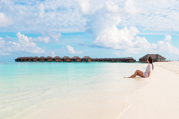 Fototapeta na wymiar Young beautiful woman relaxing on beach during tropical vacation
