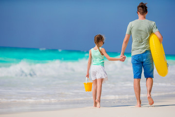 Family of father and little girl at tropical beach together