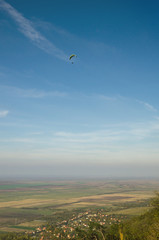 Paragliding above the suburb of town in the valley