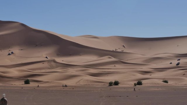 Four wheel drives in the Sahara, traditional entertainment for tourists in Moroccan desert  4K