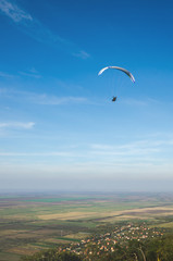 Fototapeta na wymiar Paragliding over the valley