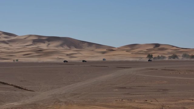 Four wheel drives in the Sahara, traditional entertainment for tourists in Moroccan desert  4K