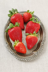 Strawberries on vintage silver plate.